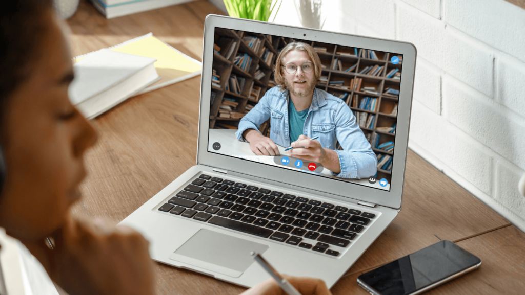 Student watching a teacher on her laptop